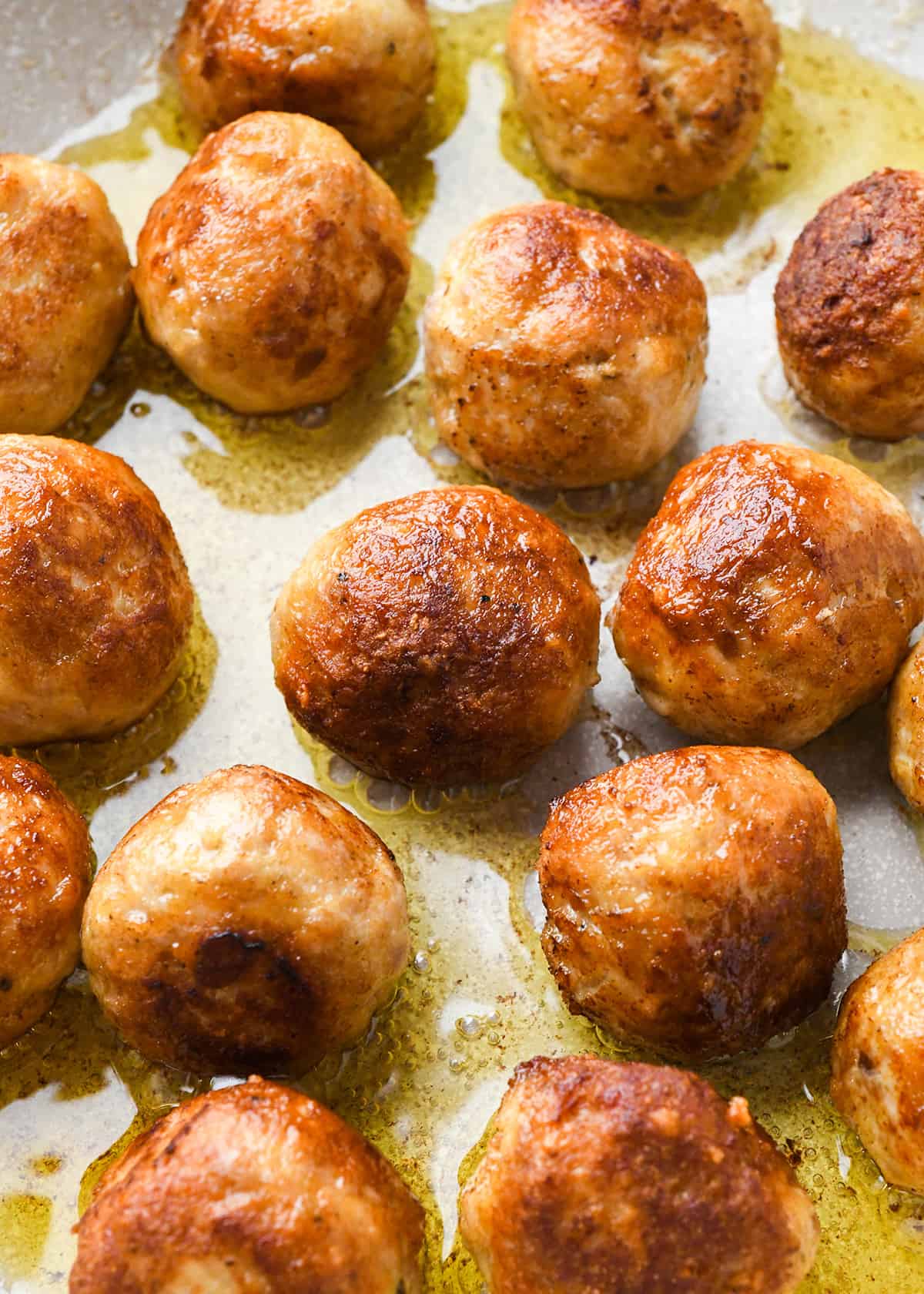 cooked chicken meatballs in a skillet