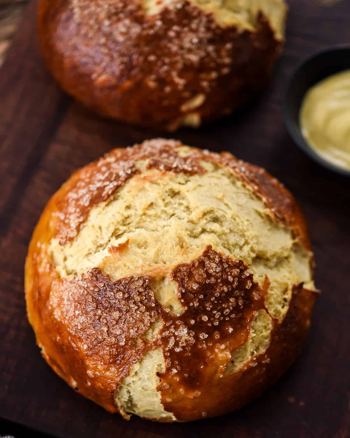 Overhead view of two loaves of homemade pretzel bread on a cutting board