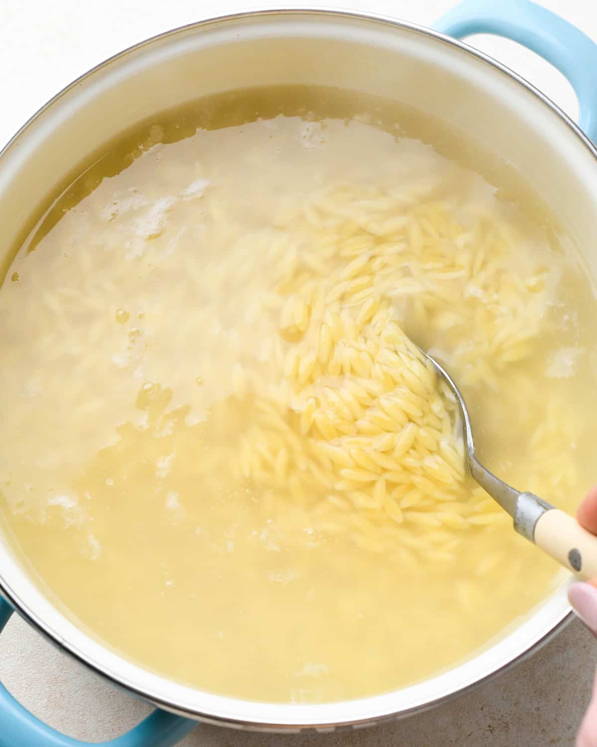 overhead photo showing orzo cooking to make Caprese Orzo Salad