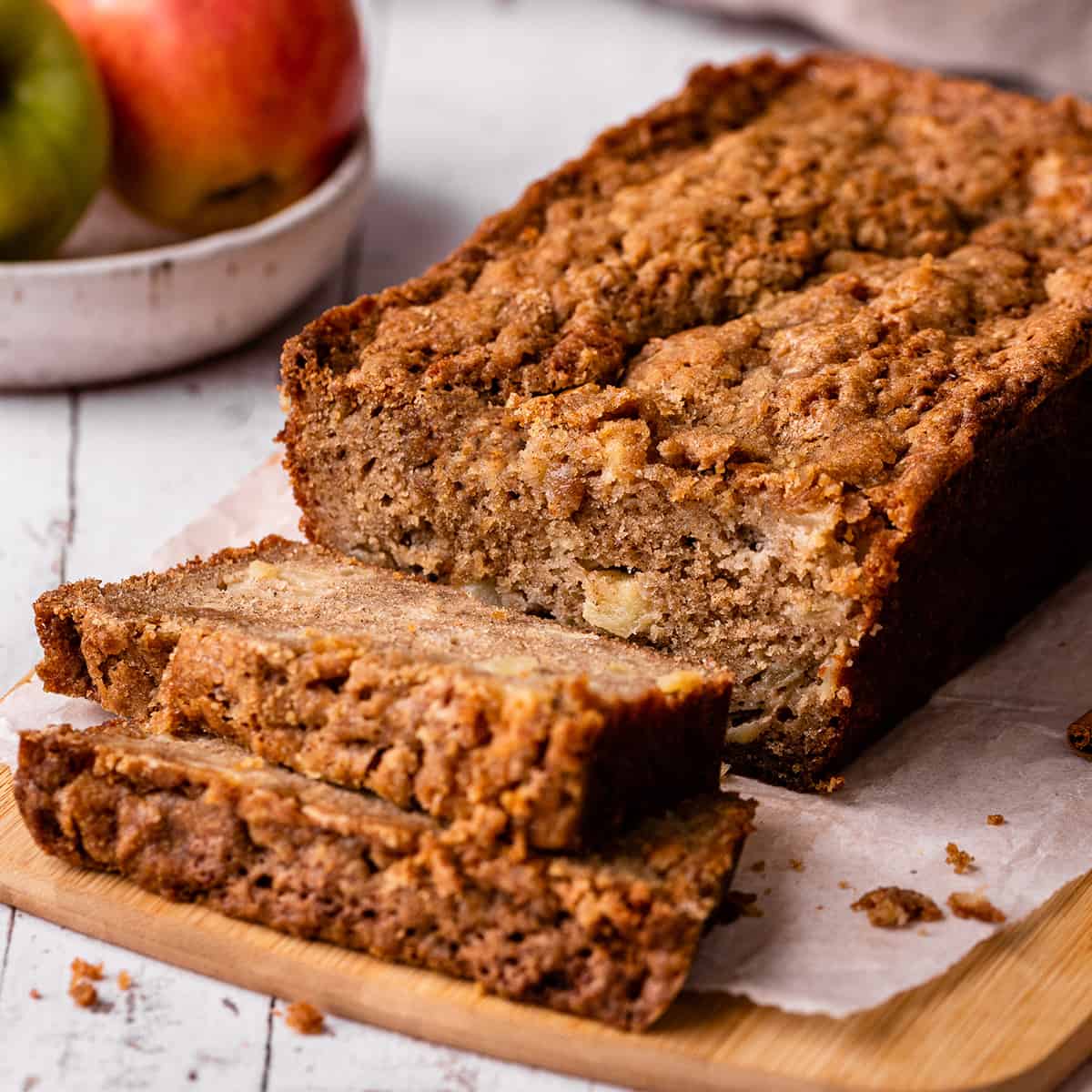 a loaf of Cinnamon Apple Bread with two slices cut out of it