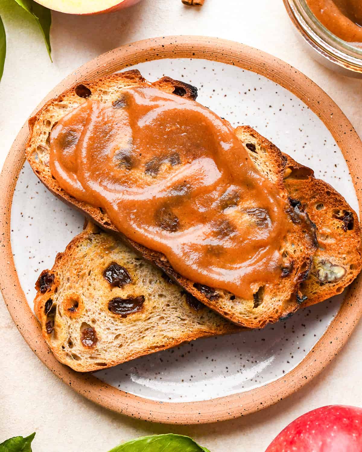 Homemade Apple Butter spread on top of a piece of toasted raisin bread