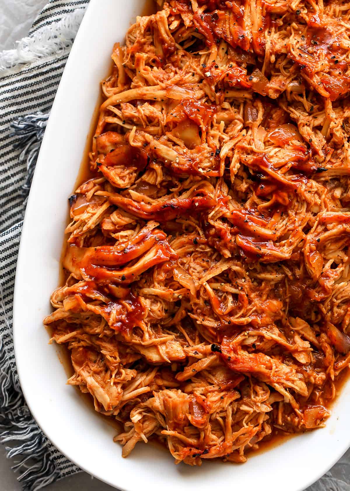 overhead view of slow cooker BBQ Chicken in a serving dish