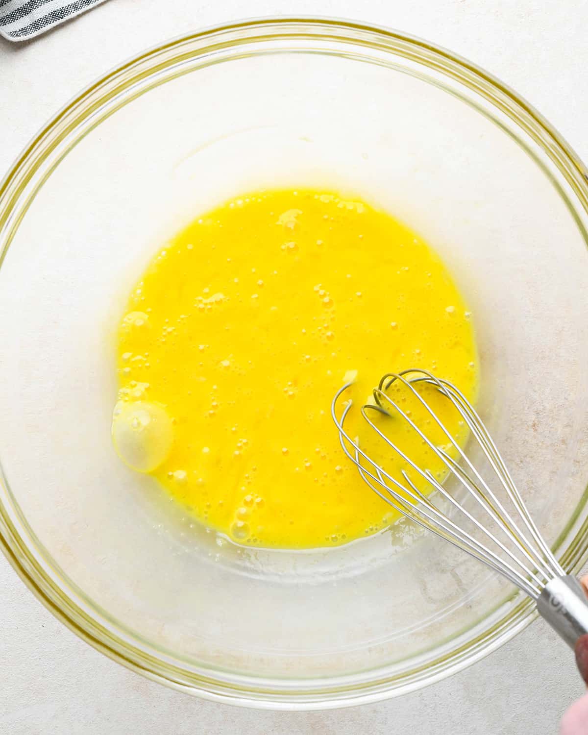 eggs being whisked in a bowl to make brownies with Homemade Brownie Mix