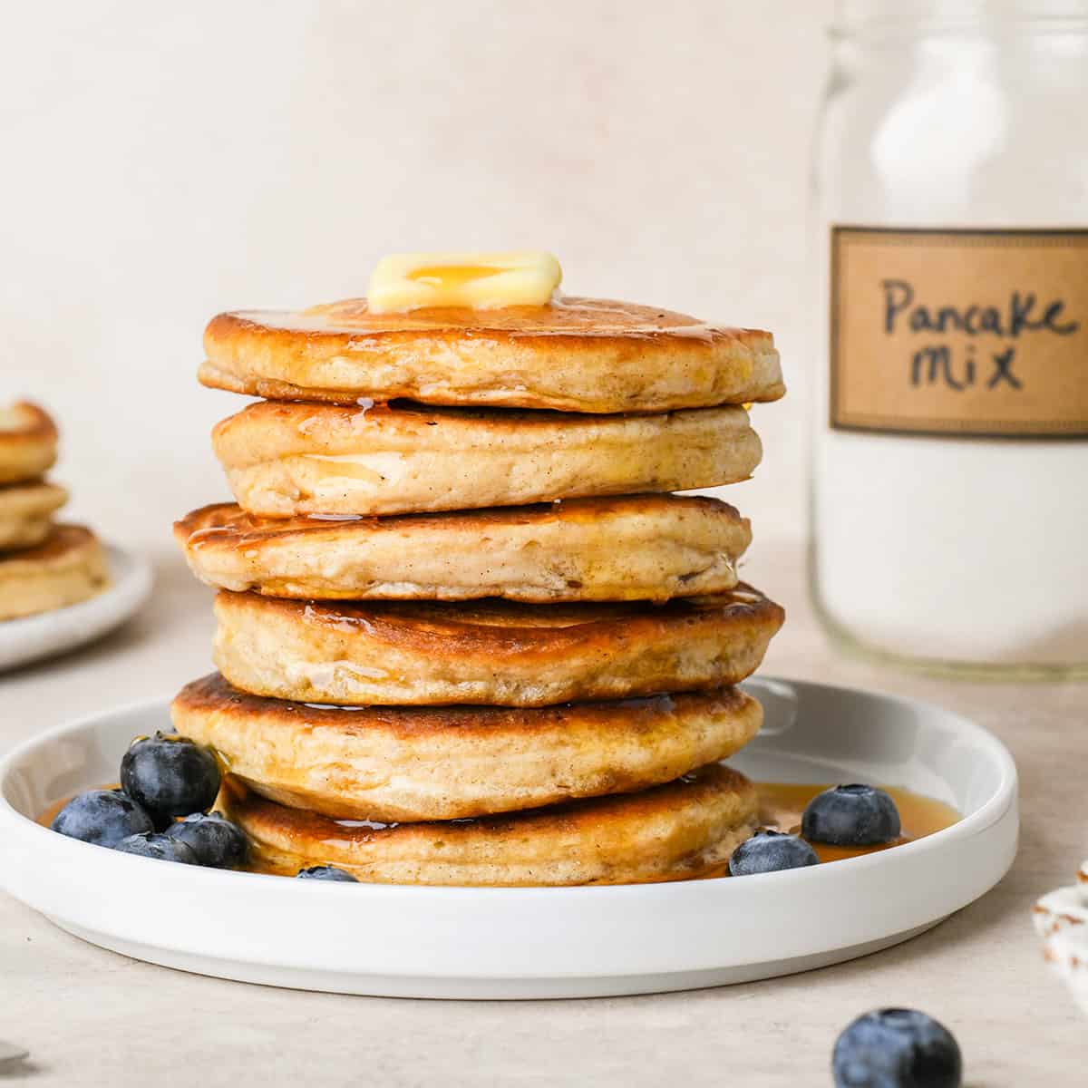 a stack of 6 pancakes topped with butter and syrup made with Homemade Pancake Mix