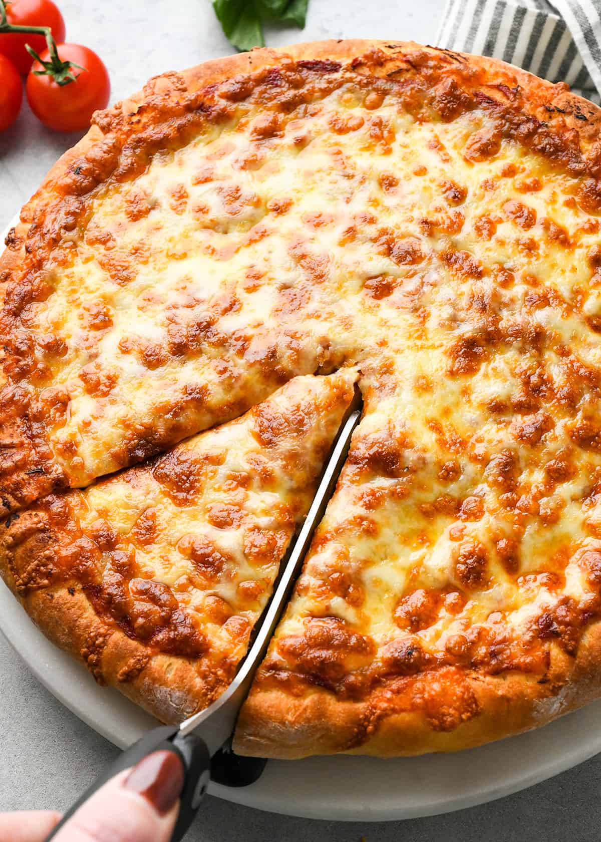 Homemade Pizza being cut with pizza scissors