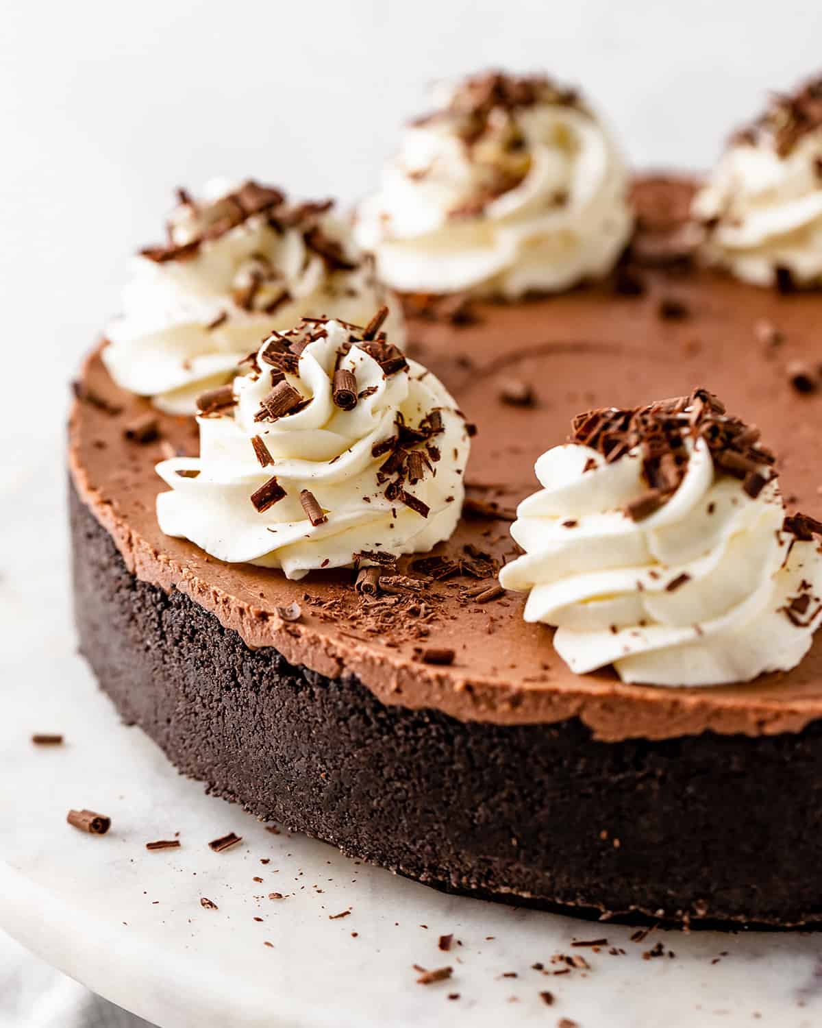 No Bake Chocolate Cheesecake with whipped cream and chocolate shavings