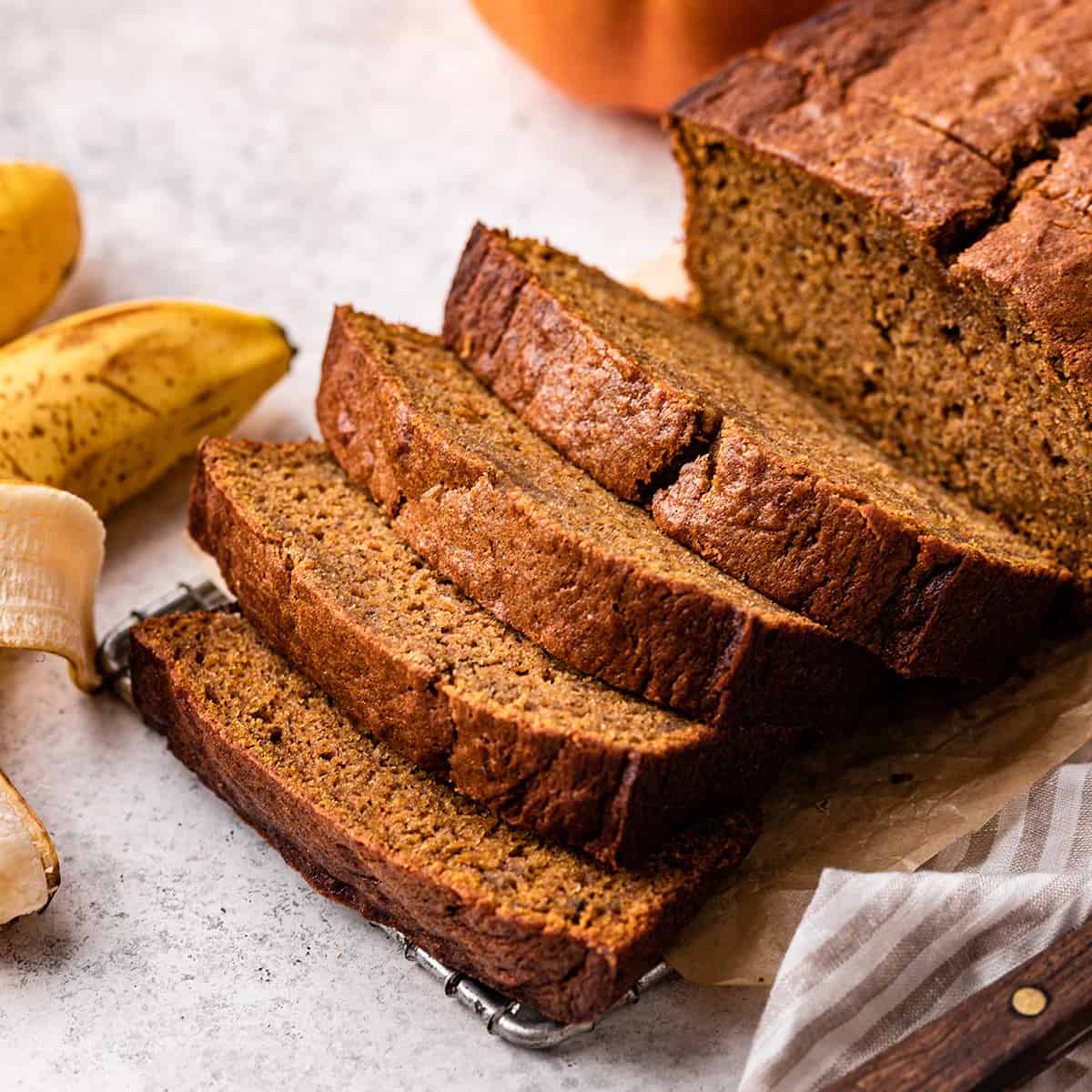 a loaf of Pumpkin Banana Bread with 5 slices cut out of it