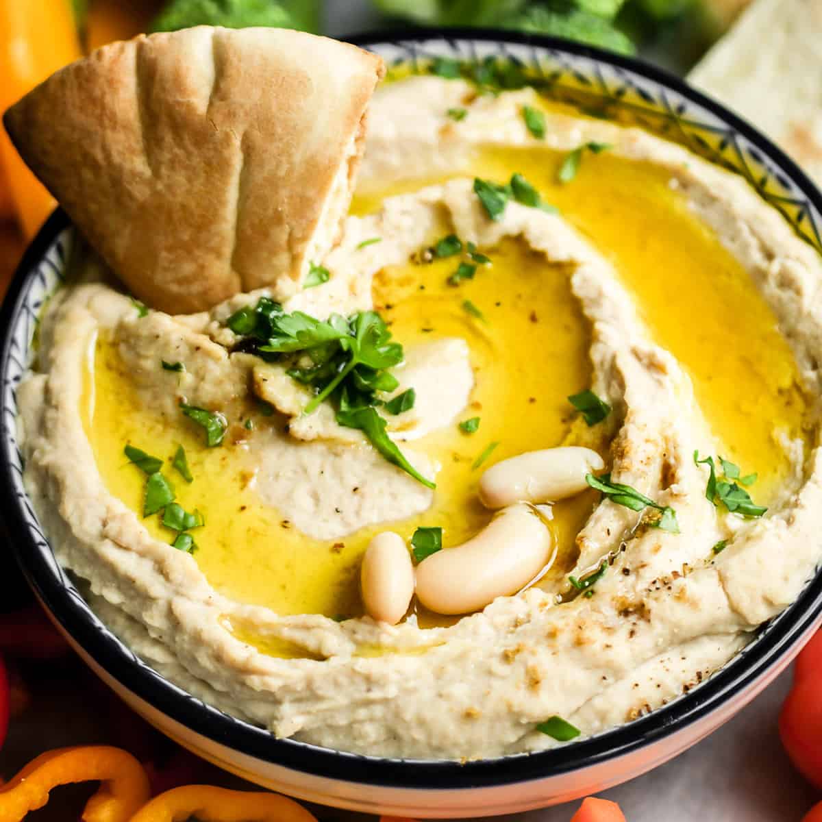 pita bread dipping into White Bean Hummus