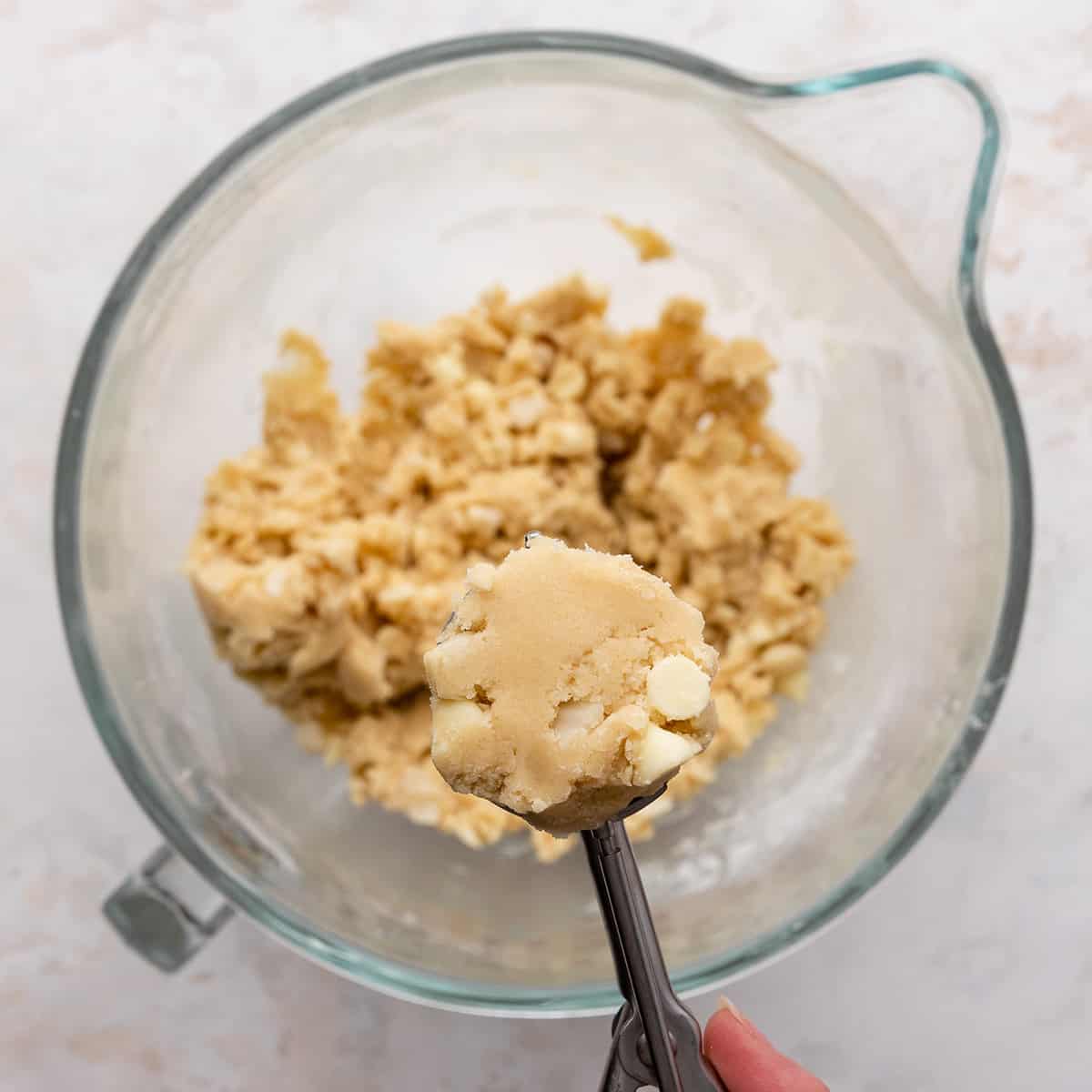 two photos showing how to make white chocolate macadamia nut cookies - portioning out dough