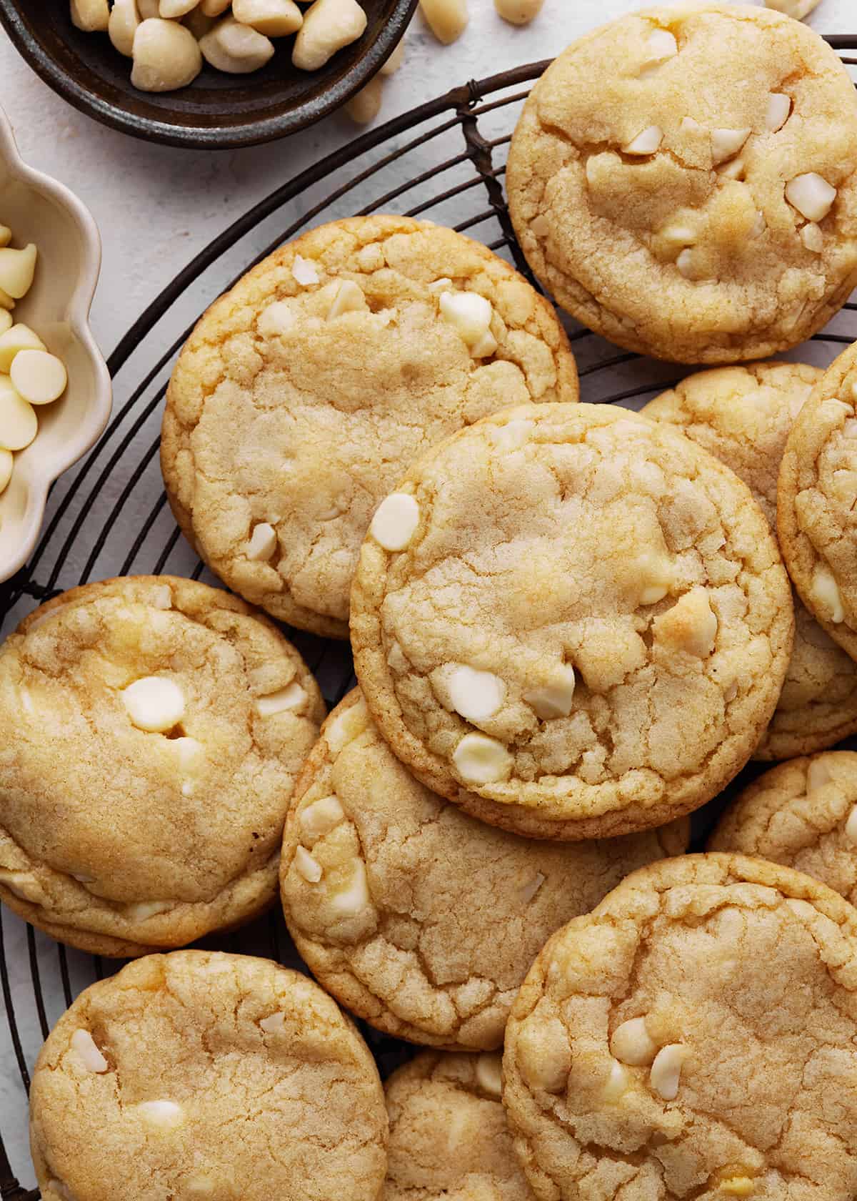 11 White Chocolate Macadamia Nut Cookies on a wire cooling rack